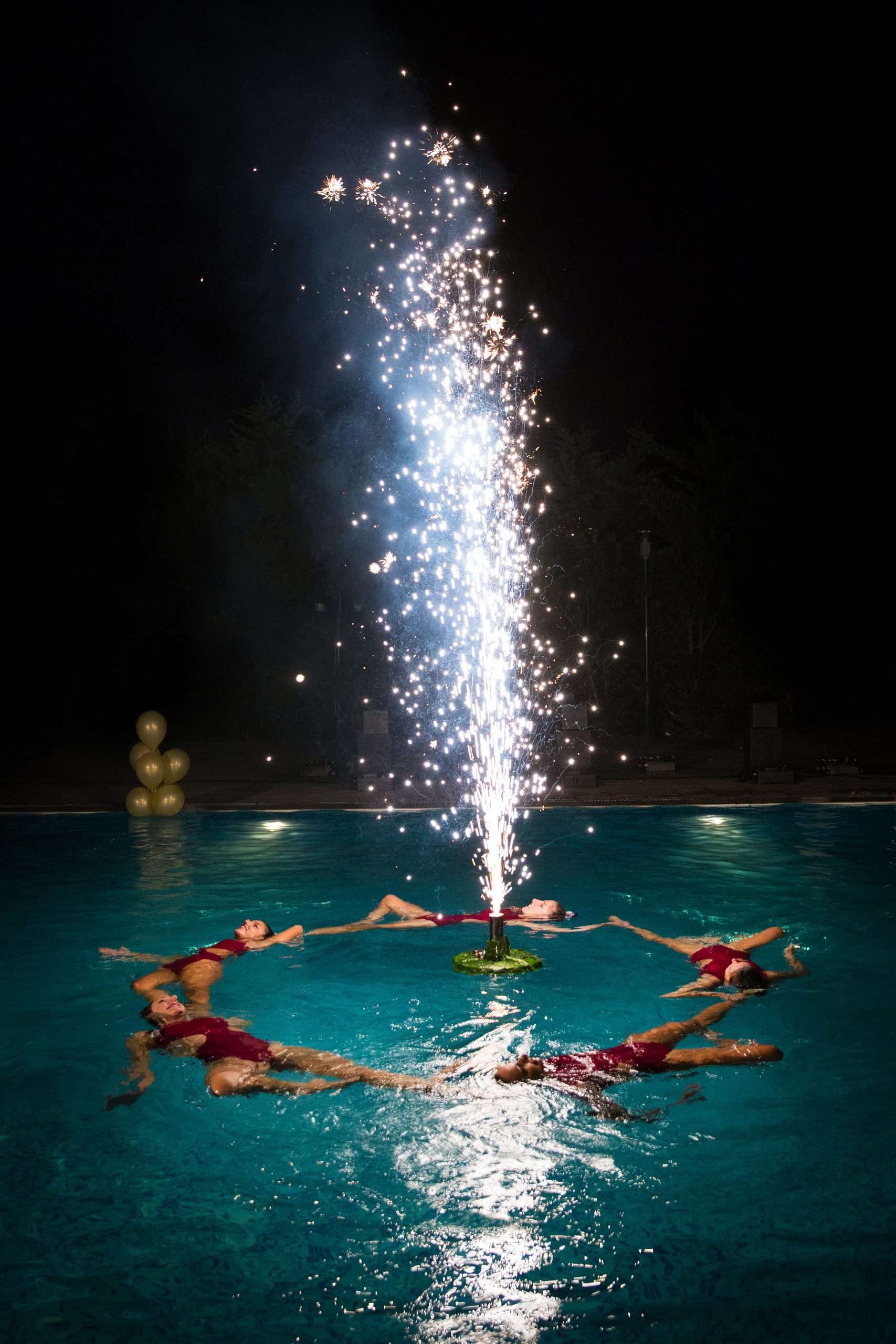 inflatable fireworks surrunded by synchronised swimmers